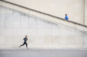 a woman running and a man running up stairs