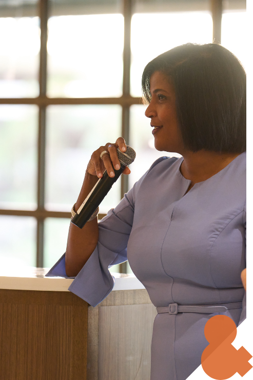 A woman  speaking at a podium